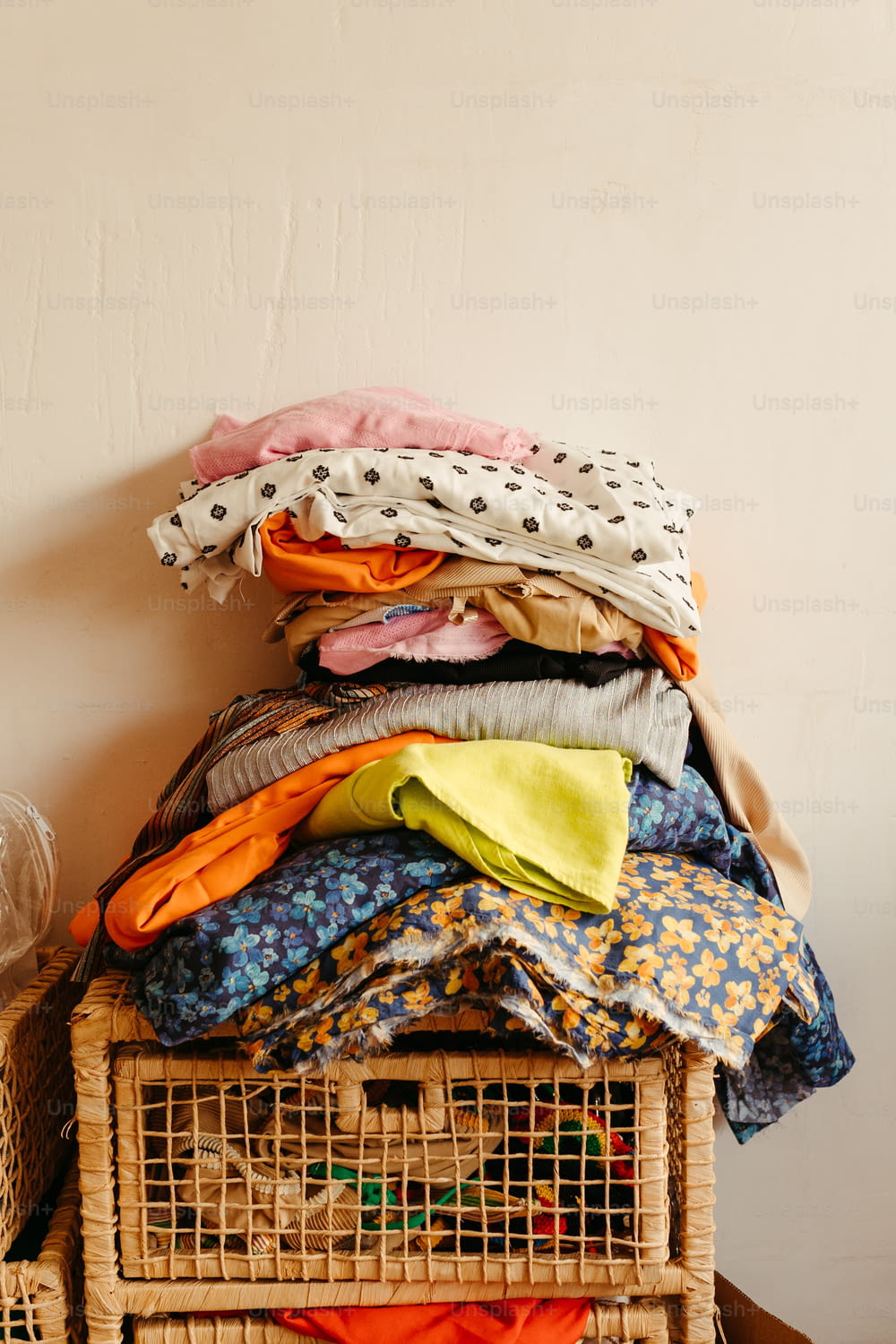 a stack of clothes sitting on top of a basket