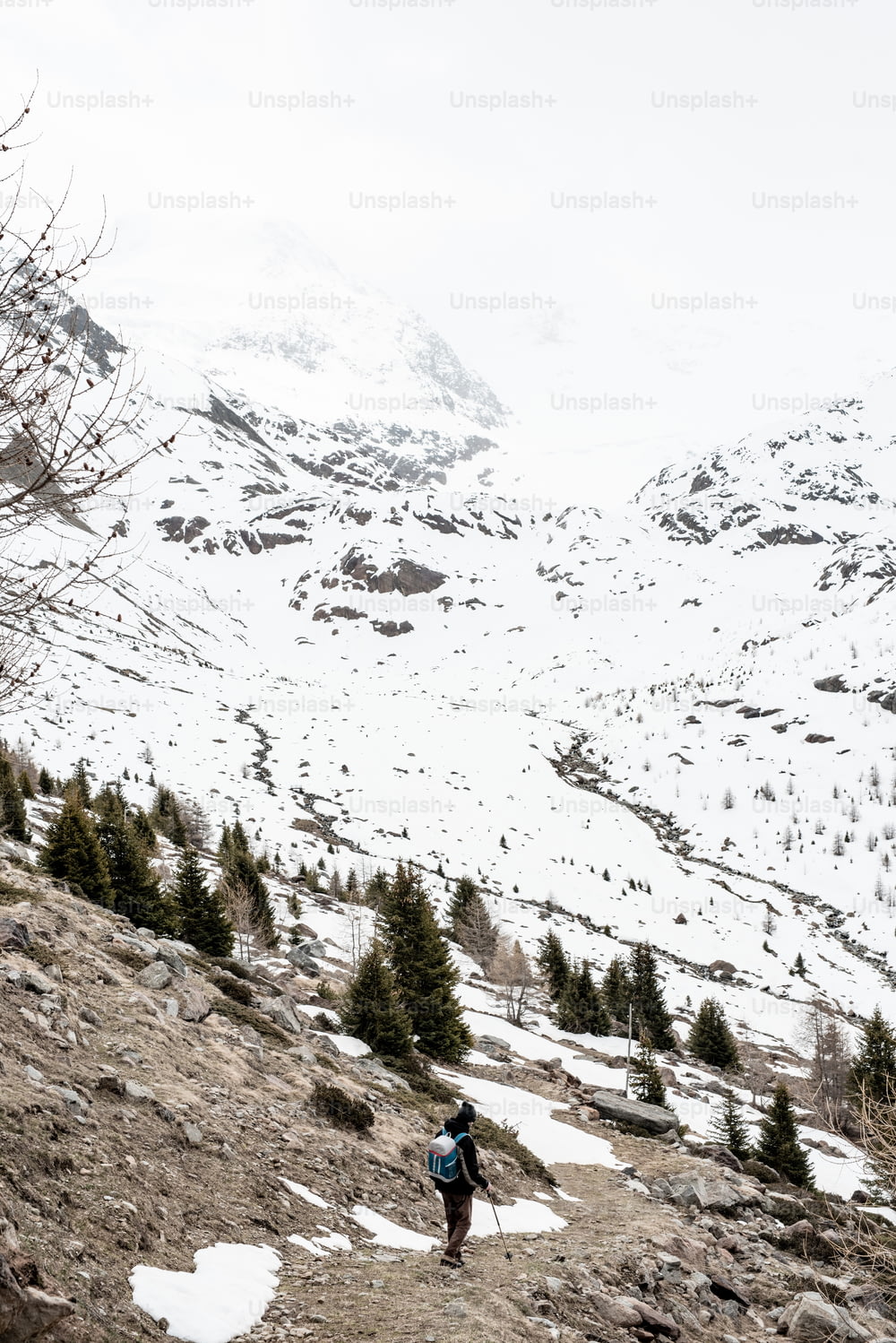 a person hiking up a snowy mountain with a backpack