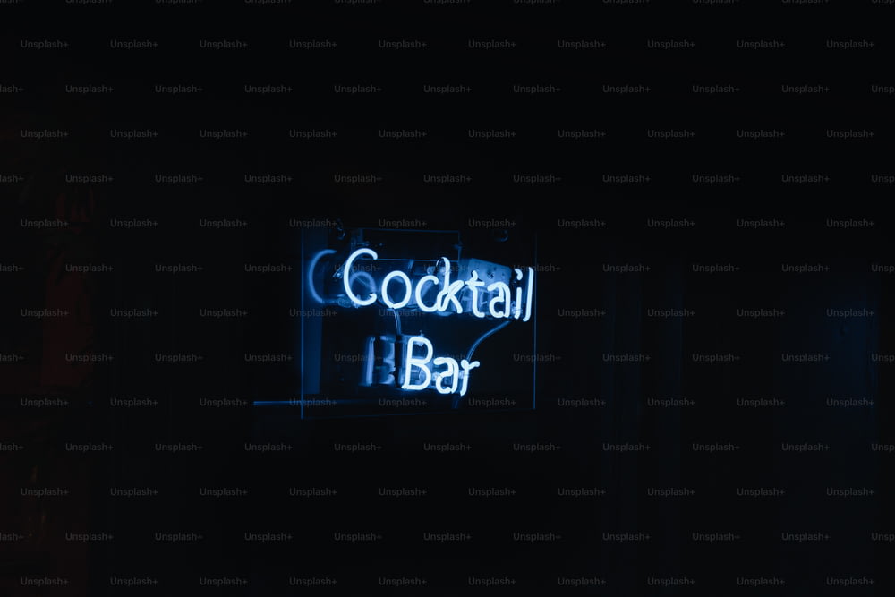 a neon sign that says cocktail bar in the dark