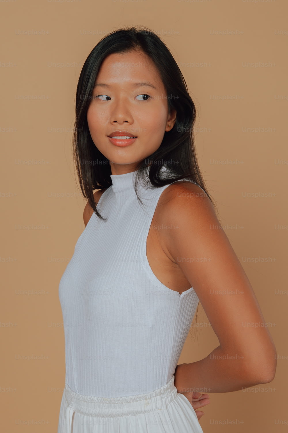 a woman in a white dress posing for a picture