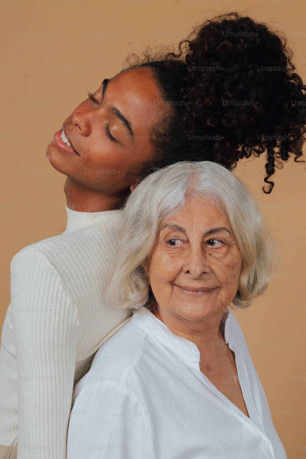 an older woman is holding a younger woman's head