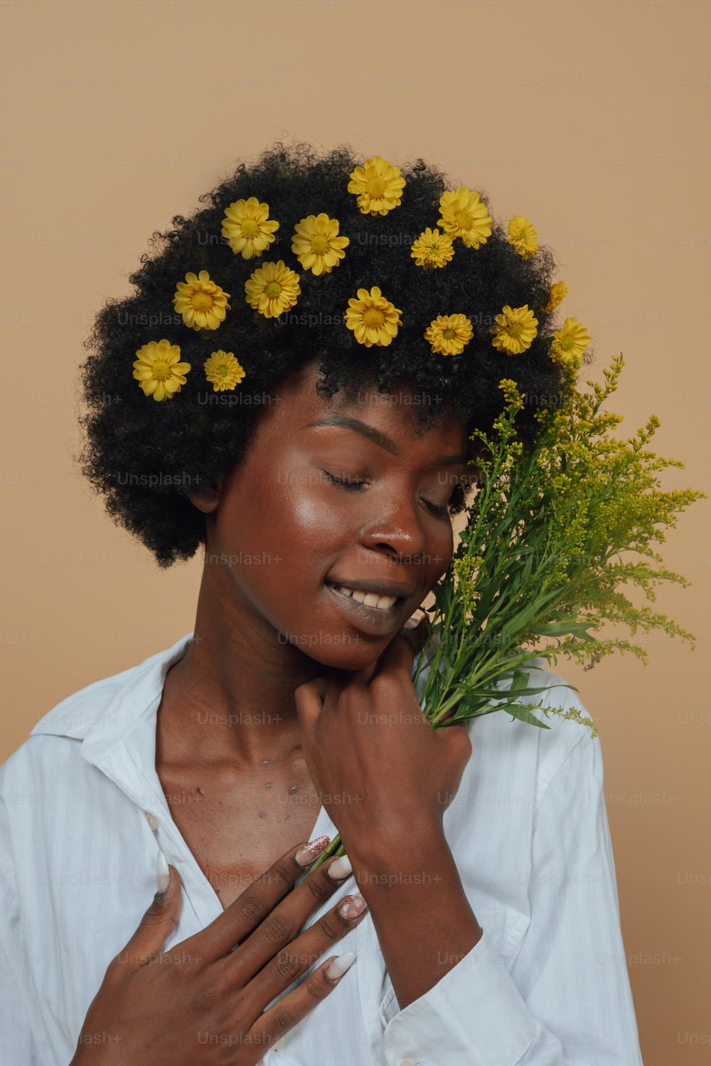 a woman holding a bunch of flowers in her hair