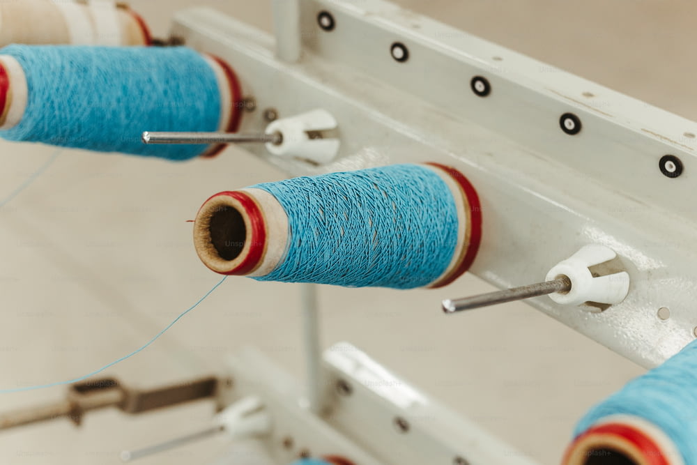 a couple of spools of thread on a machine