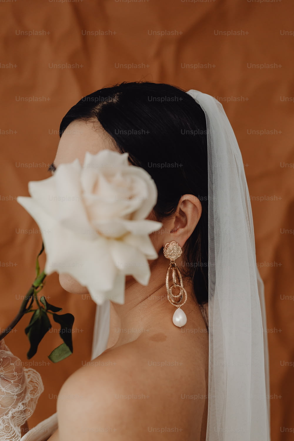 a woman in a wedding dress with a flower in her hair