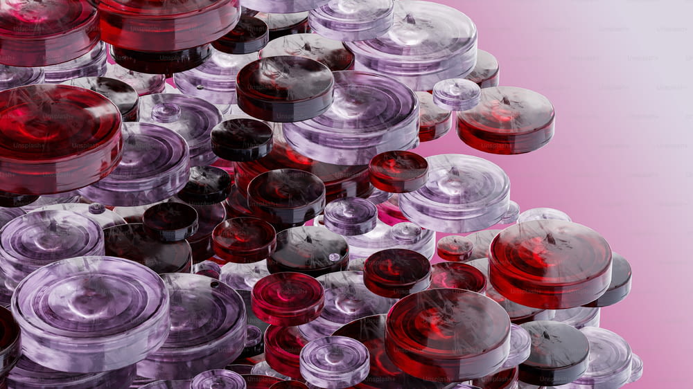 a pile of red and purple jars sitting on top of each other