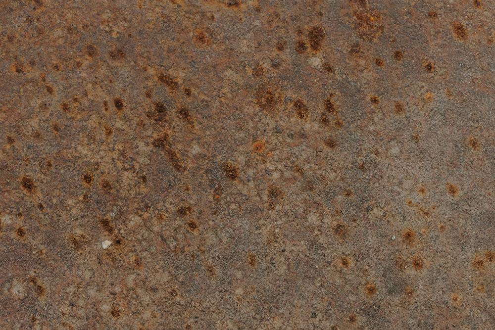 a close up of a metal surface with rust on it