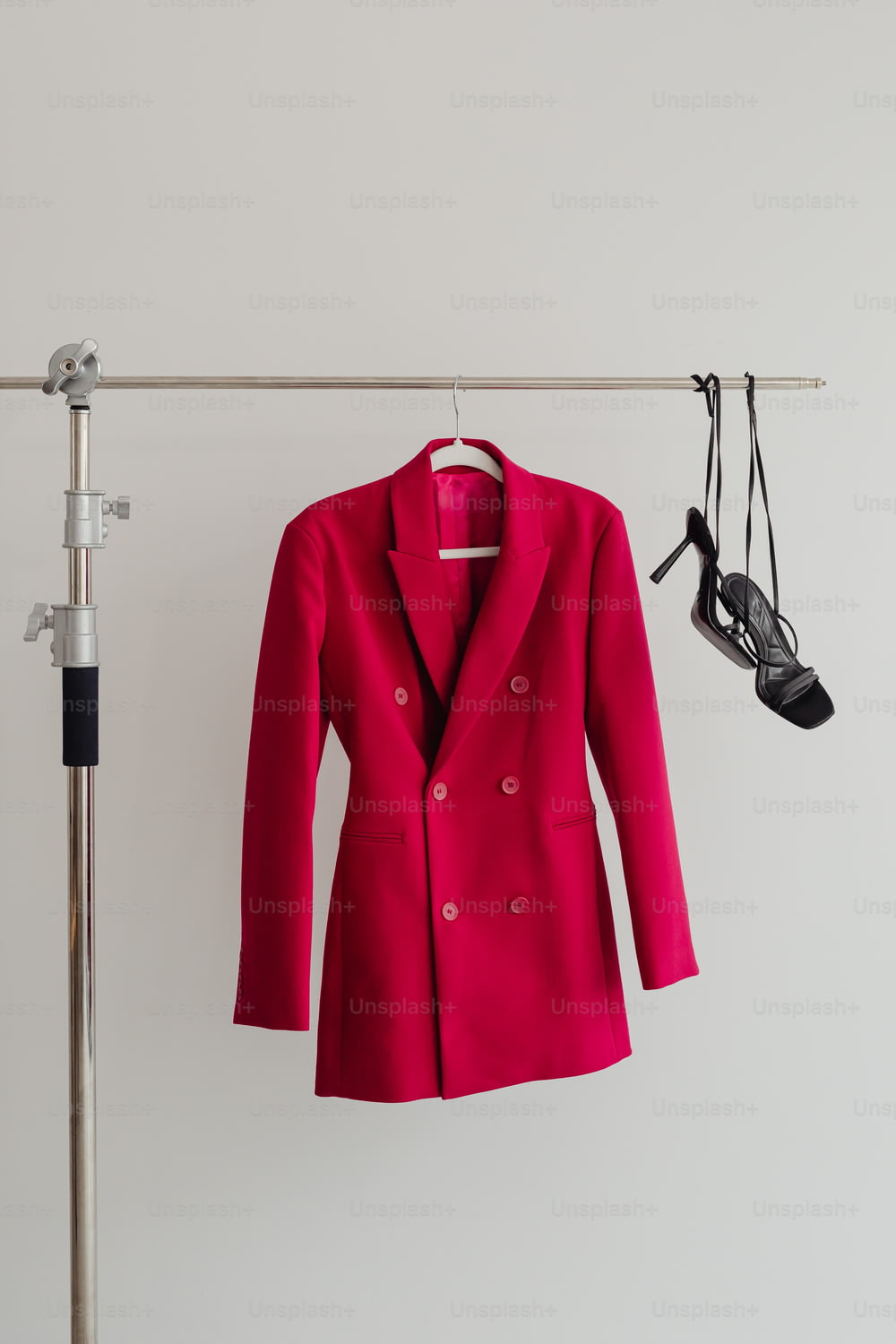 a red jacket hanging on a clothes rack
