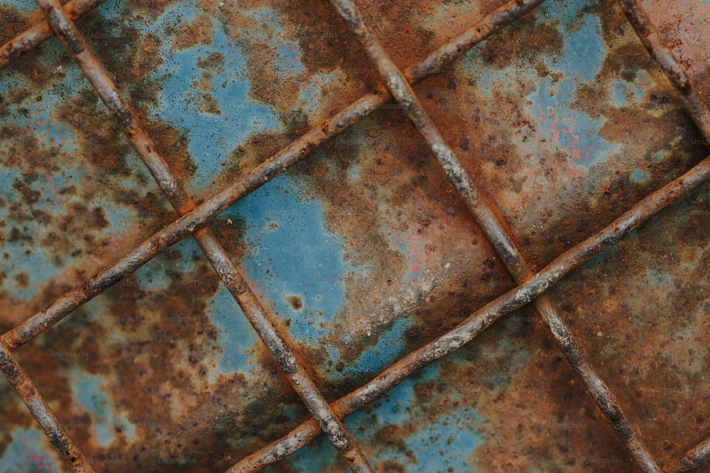 a rusted metal surface with blue and brown squares