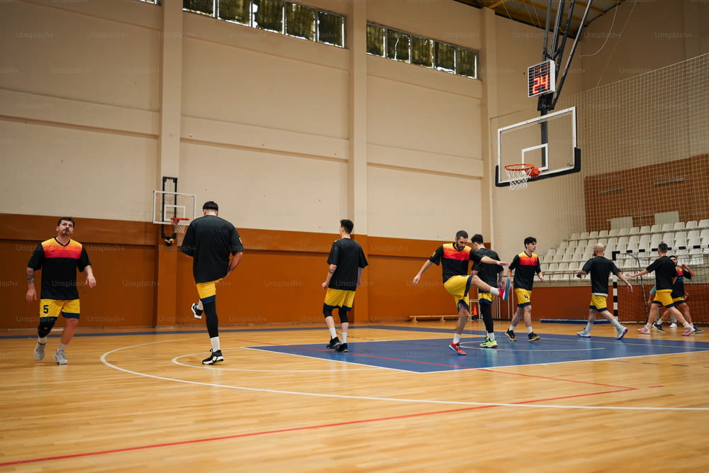 a group of young men playing a game of basketball