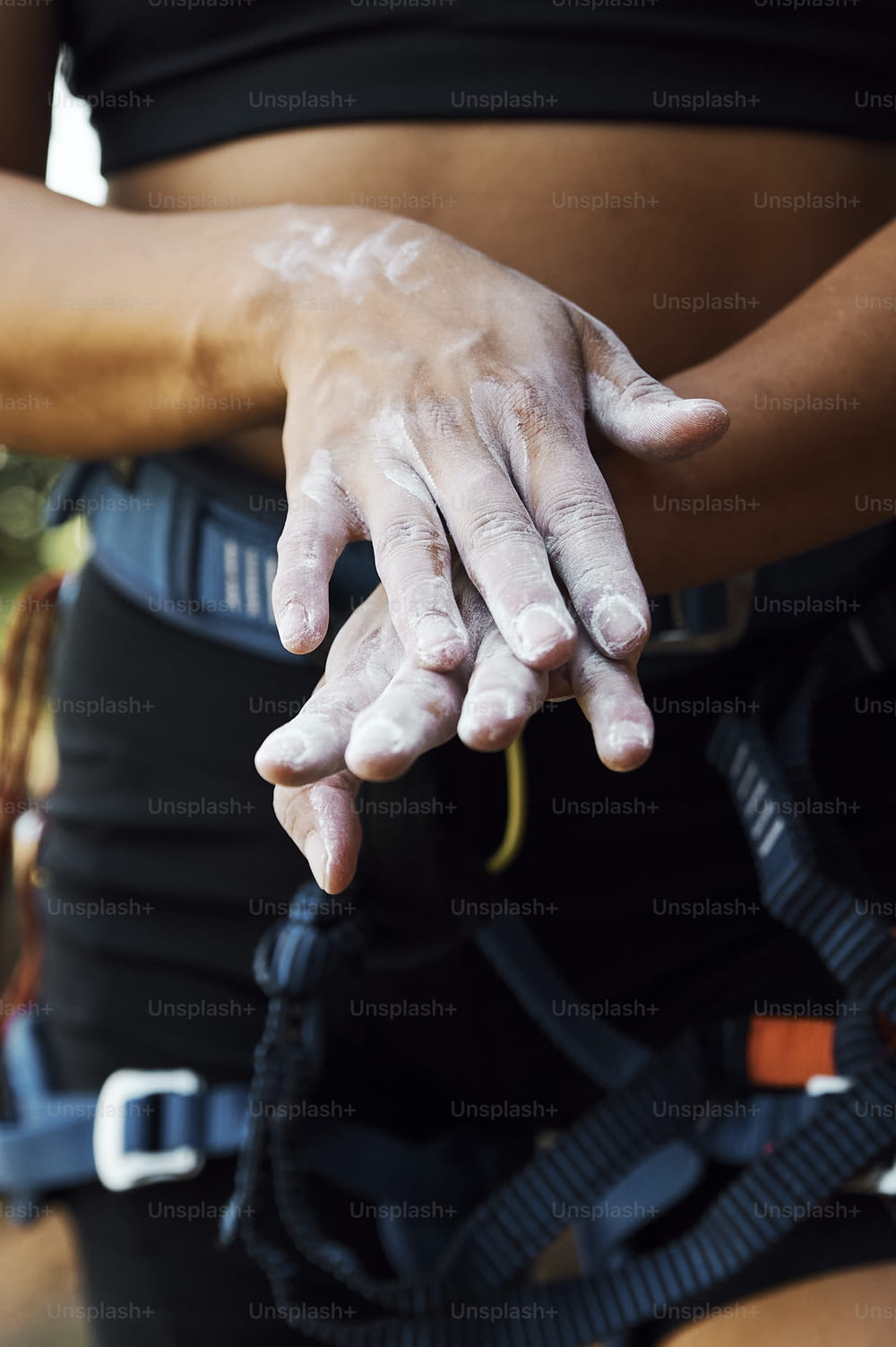 a close up of a person's hands with mud on them