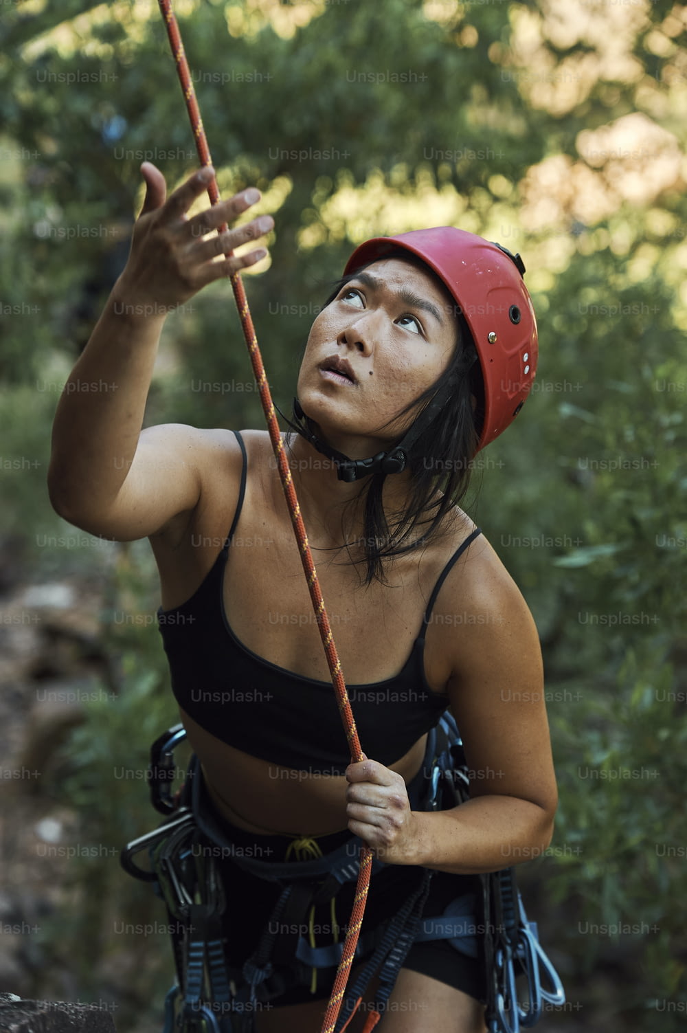 a woman in a red helmet is climbing
