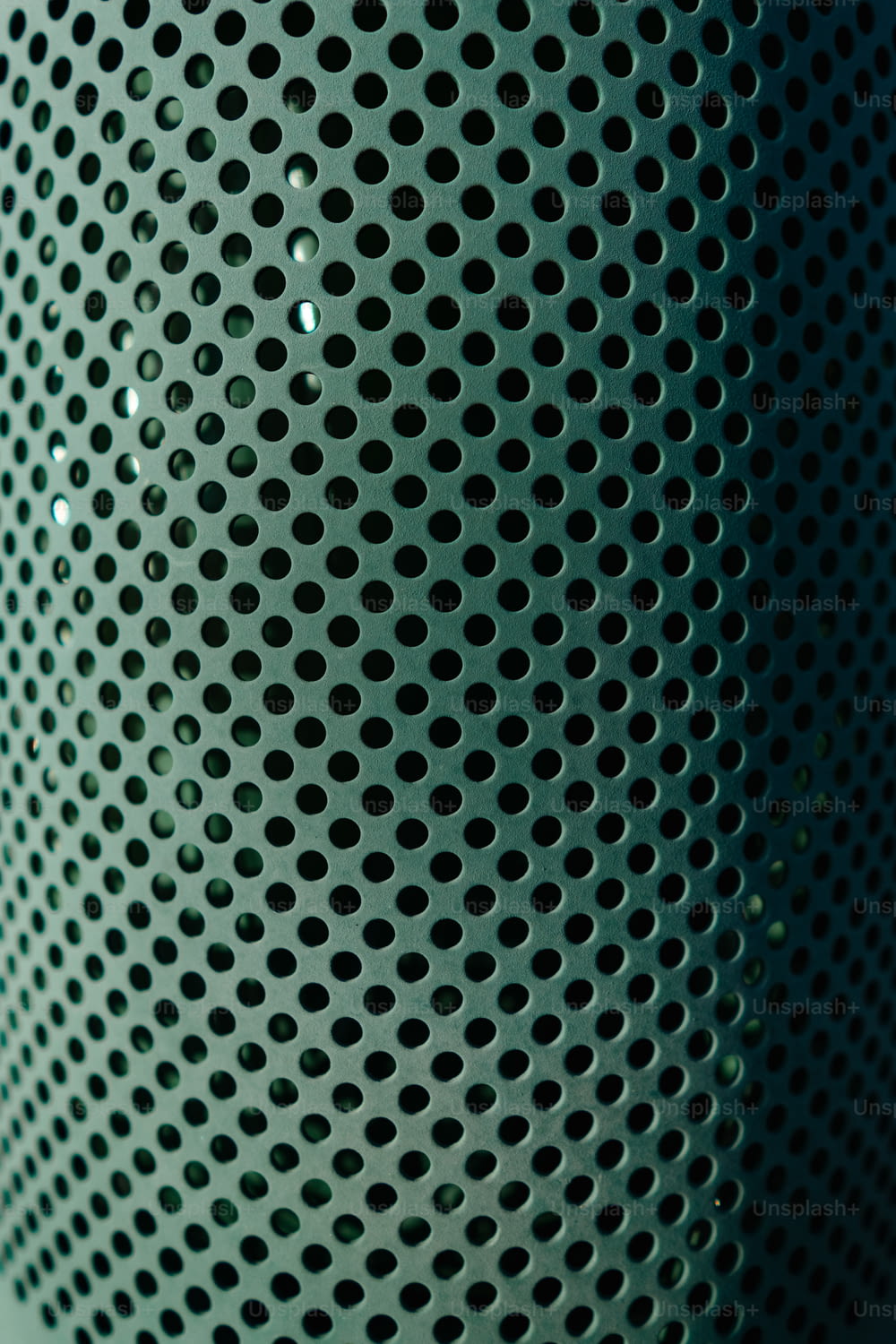 a close up of a metal object with holes