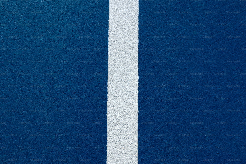 a white line painted on the side of a blue wall