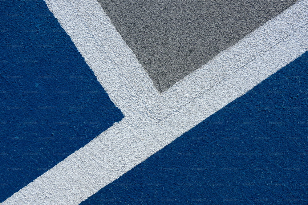 a close up of a blue and white wall