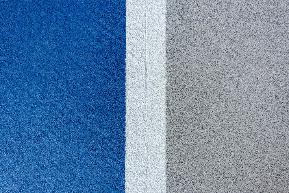 a blue and grey wall with a white stripe