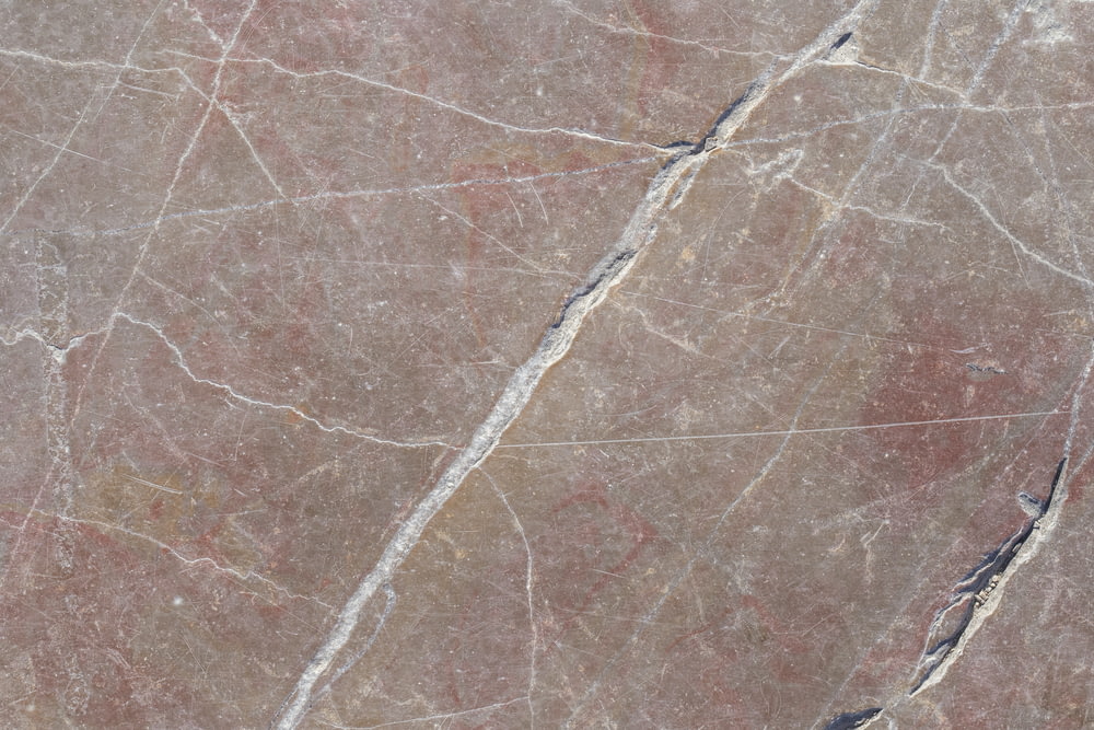 a close up of a marble surface with cracks in it