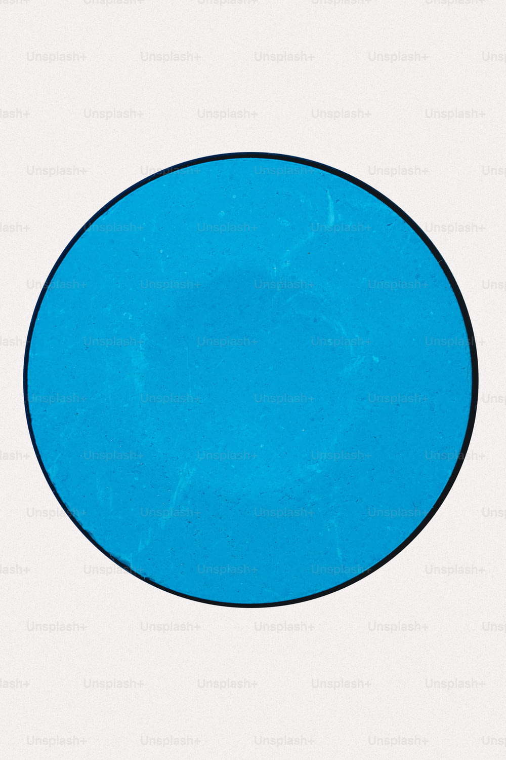a blue circle with a black border on a white background
