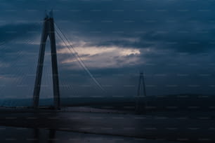 a very tall bridge with a cloudy sky in the background