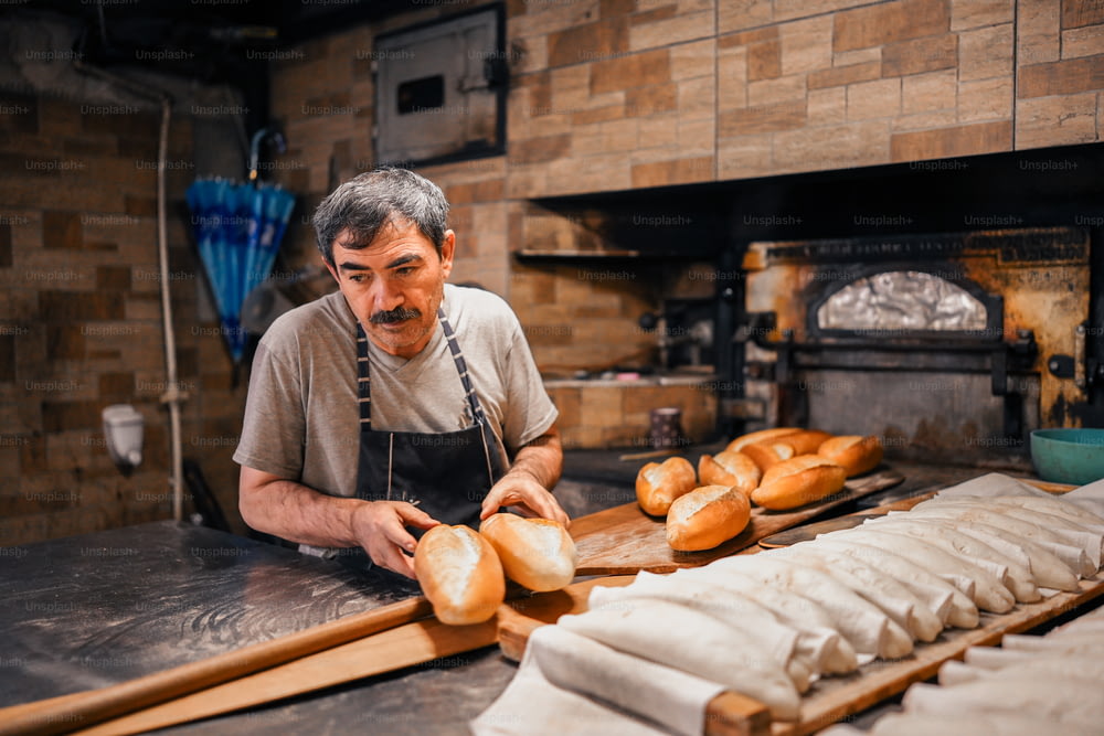 a man in a bakery making bread