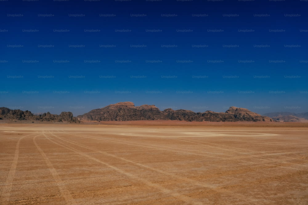 a large open field with mountains in the background