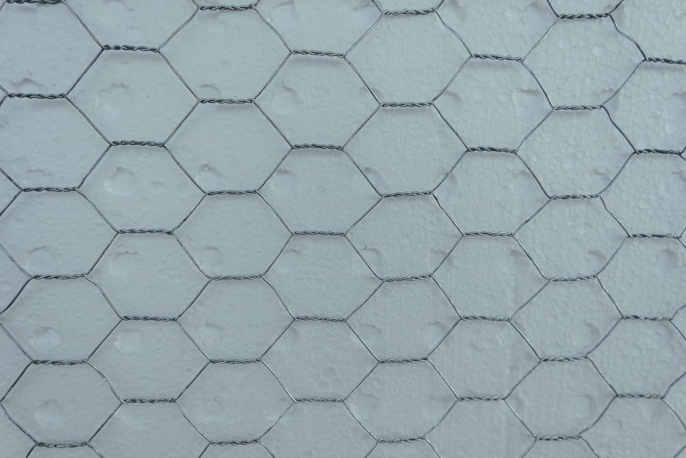 a close up of a white wall with a hexagonal pattern