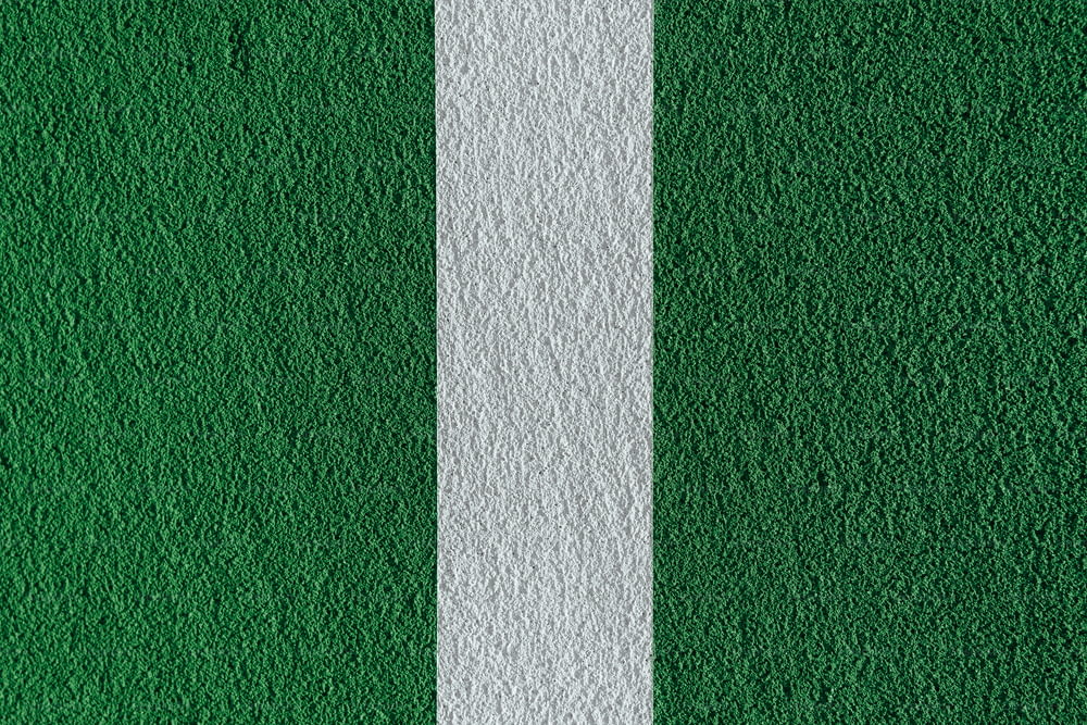 a close up of a white line on a green wall