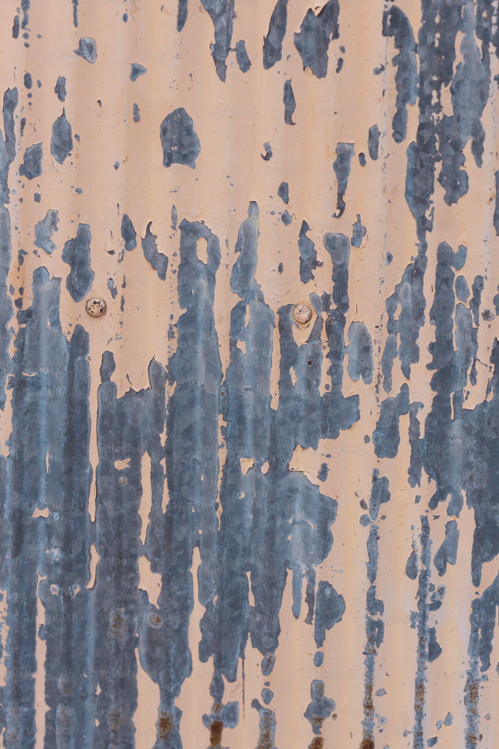 a rusted metal surface with blue and white paint