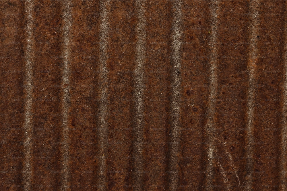 a close up of a metal sheet with rust on it