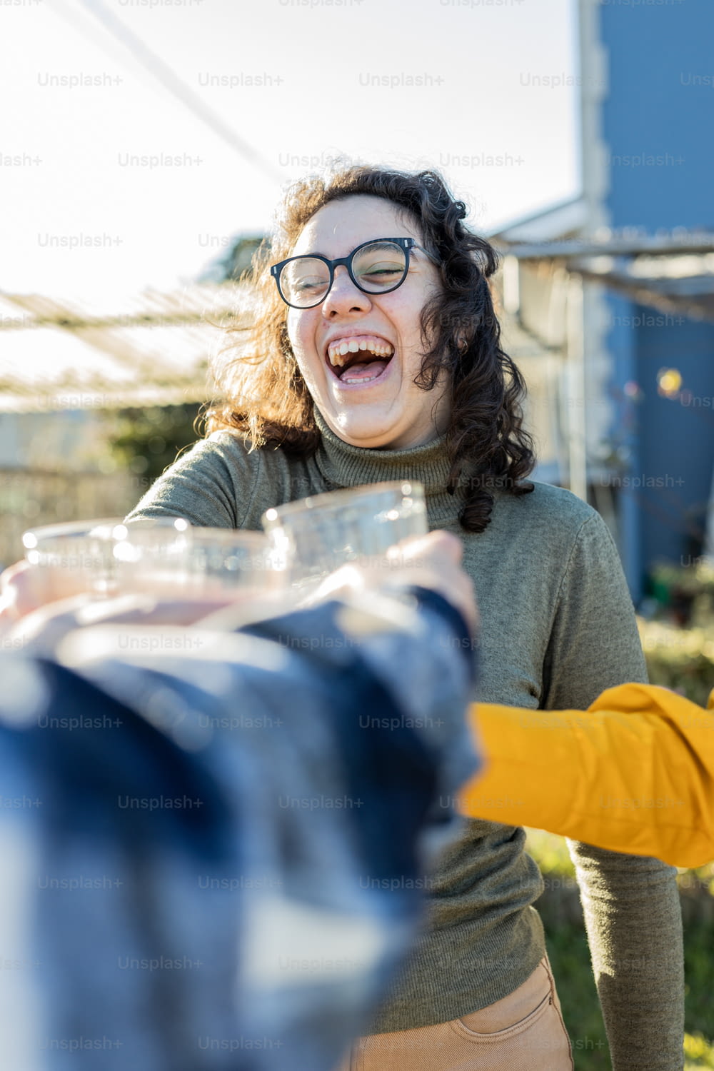 a woman laughing while holding a plastic container