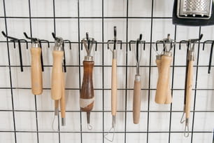 a bunch of kitchen utensils hanging on a wall