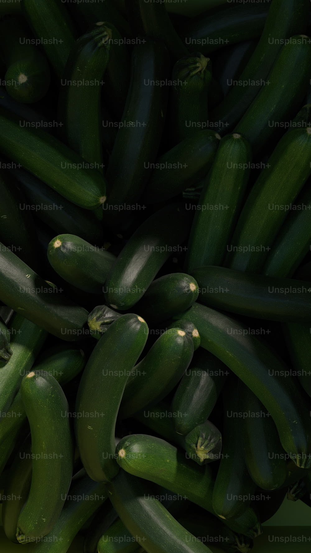 a pile of green cucumbers sitting next to each other