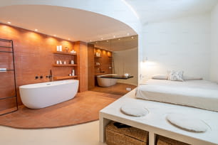 a large white bath tub sitting inside of a bathroom