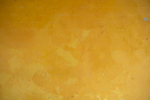 a yellow wall with a clock on it