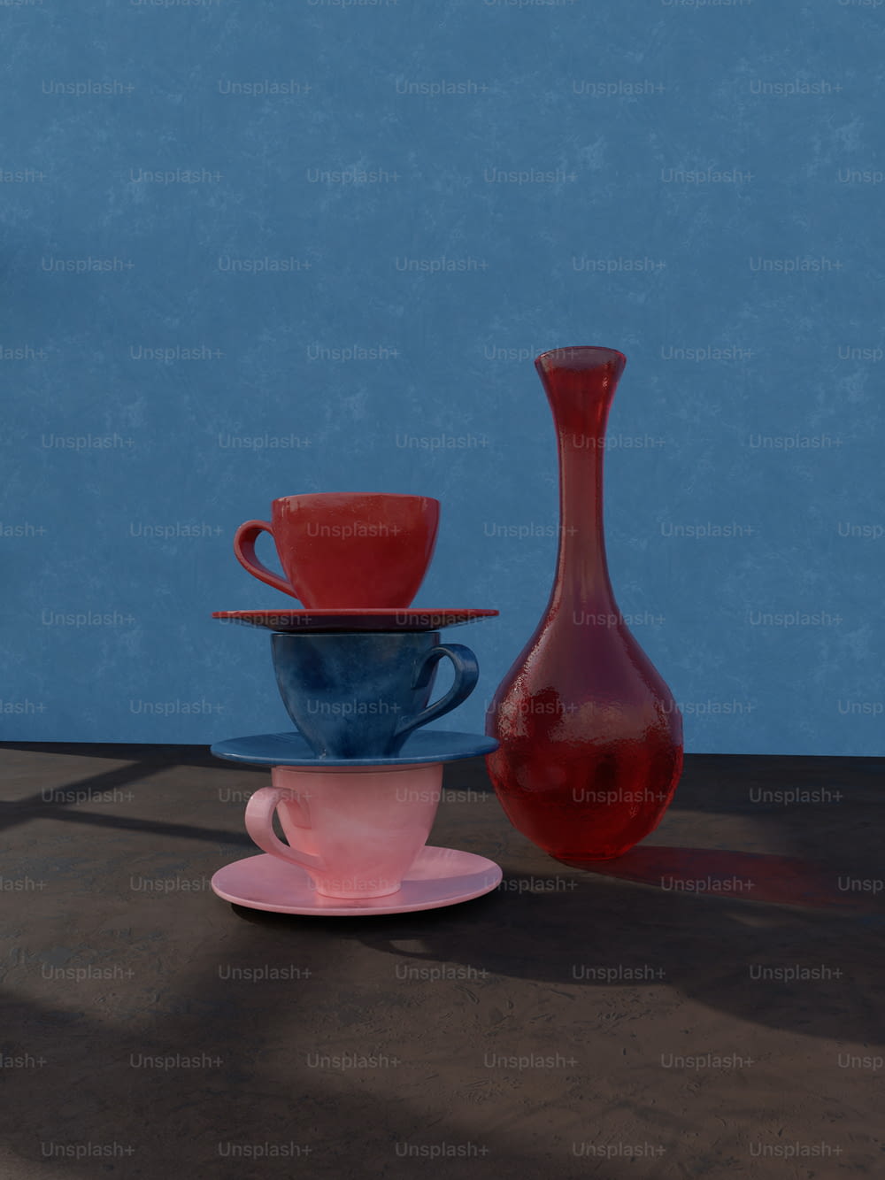 three cups and a vase on a table