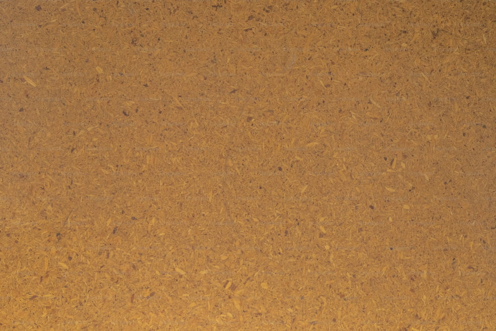 a close up of a brown surface with small dots