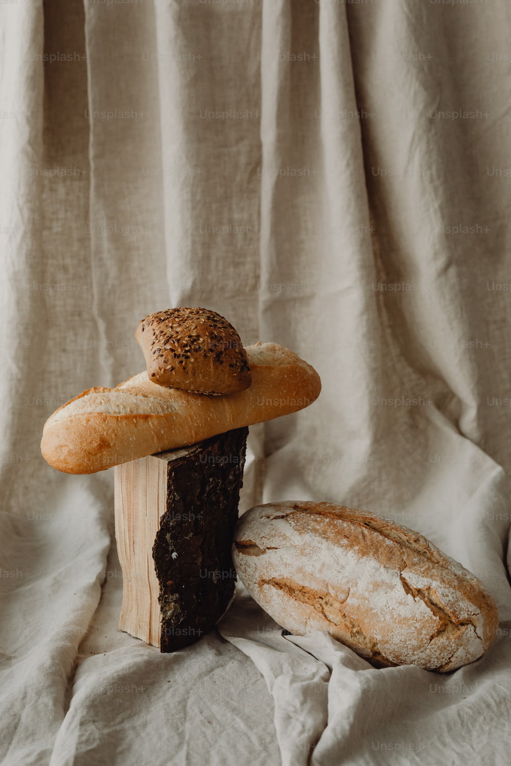 a couple of breads sitting on top of a wooden block