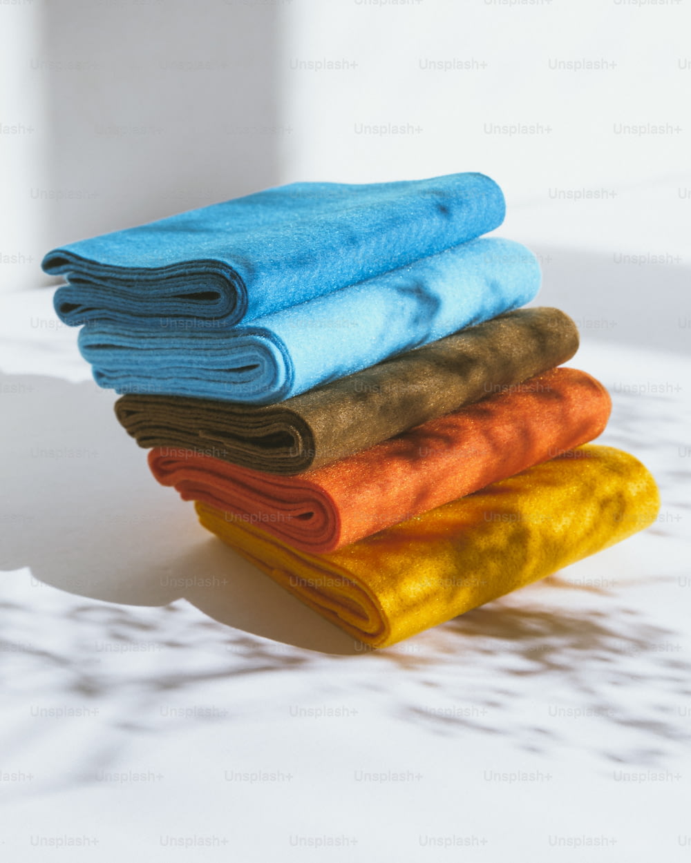 a stack of towels sitting on top of a white table