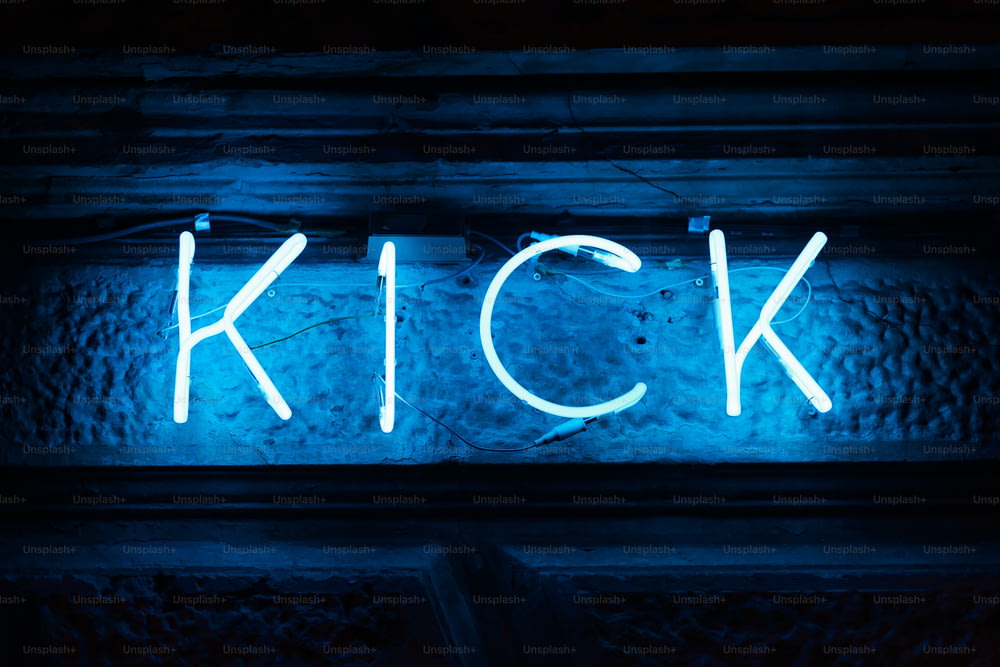 a neon sign that reads kick on a wall