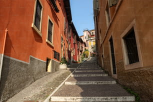 a narrow cobblestone street lined with buildings