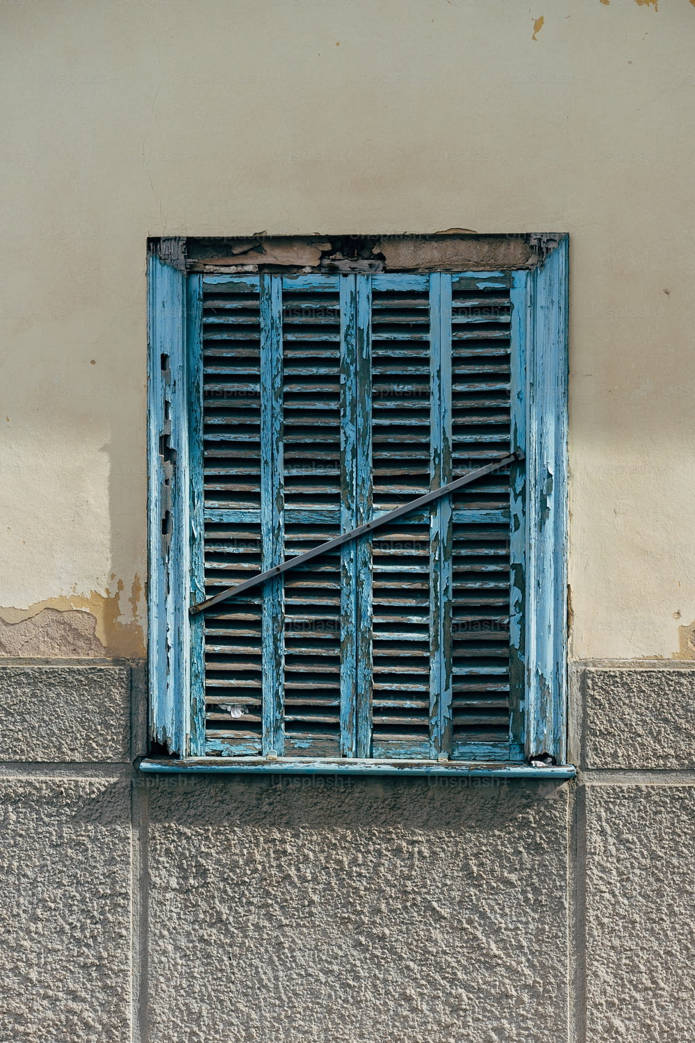 una ventana azul con un palo largo que sobresale de ella