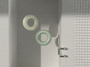 a bathroom with a white tiled wall and a green and white toilet