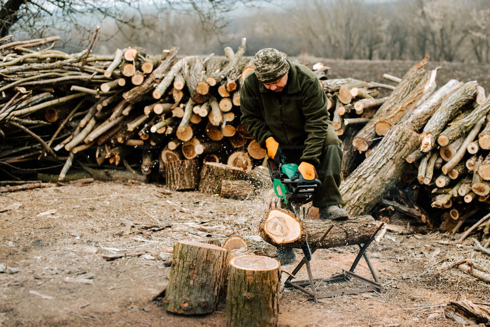 a man chopping wood with a chainsaw
