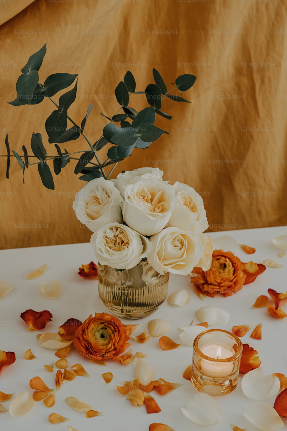 a vase filled with white roses on top of a table