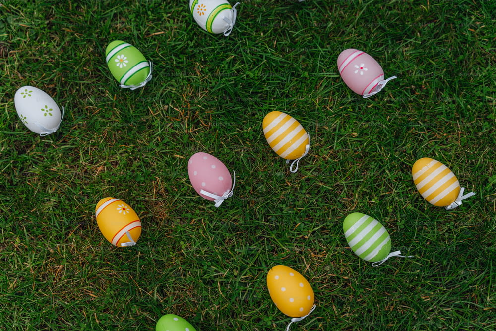a group of easter eggs sitting on top of a lush green field