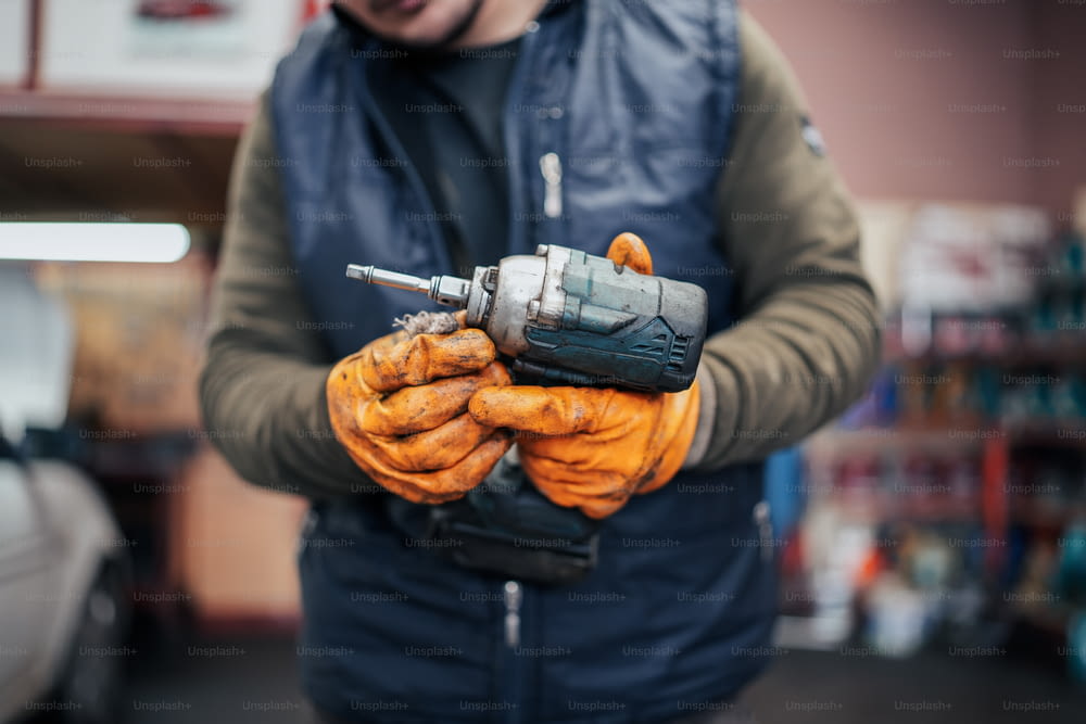 a man holding a drill in his hands