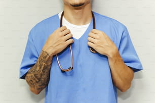 a man with a tattoo on his arm and a stethoscope around his