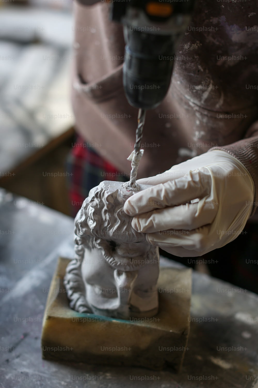 a statue being worked on with a drill