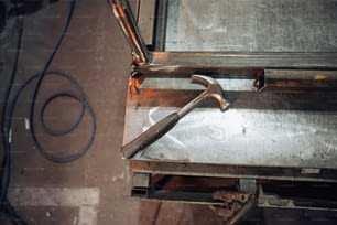 a hammer and a wrench on top of a metal box