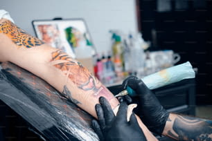 a person getting a tattoo done on their arm