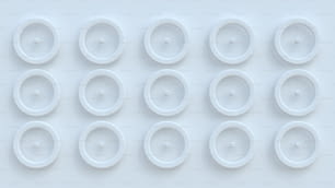 a group of white plastic wheels on a white surface